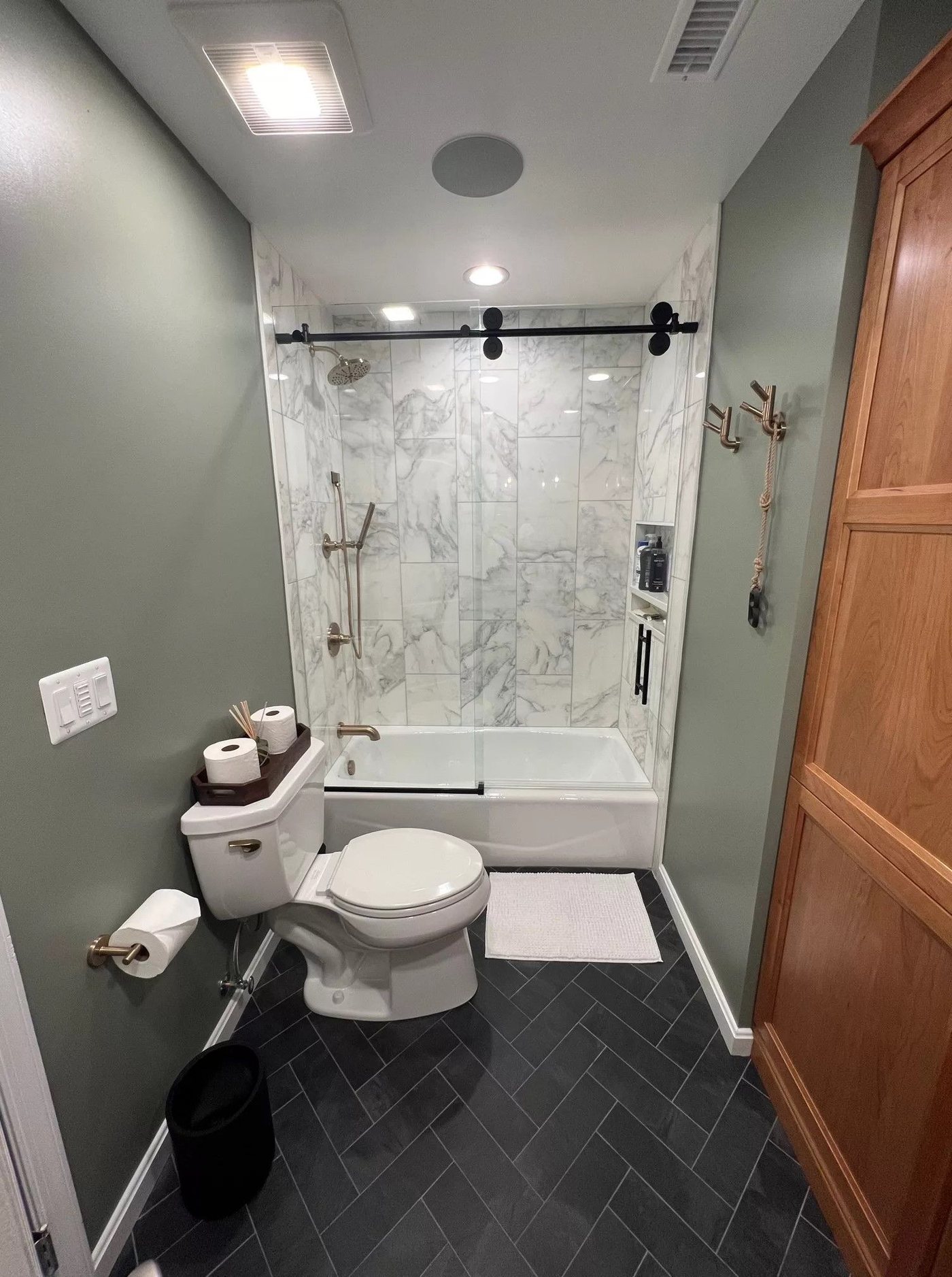 Marble tub and shower with barn-style glass door