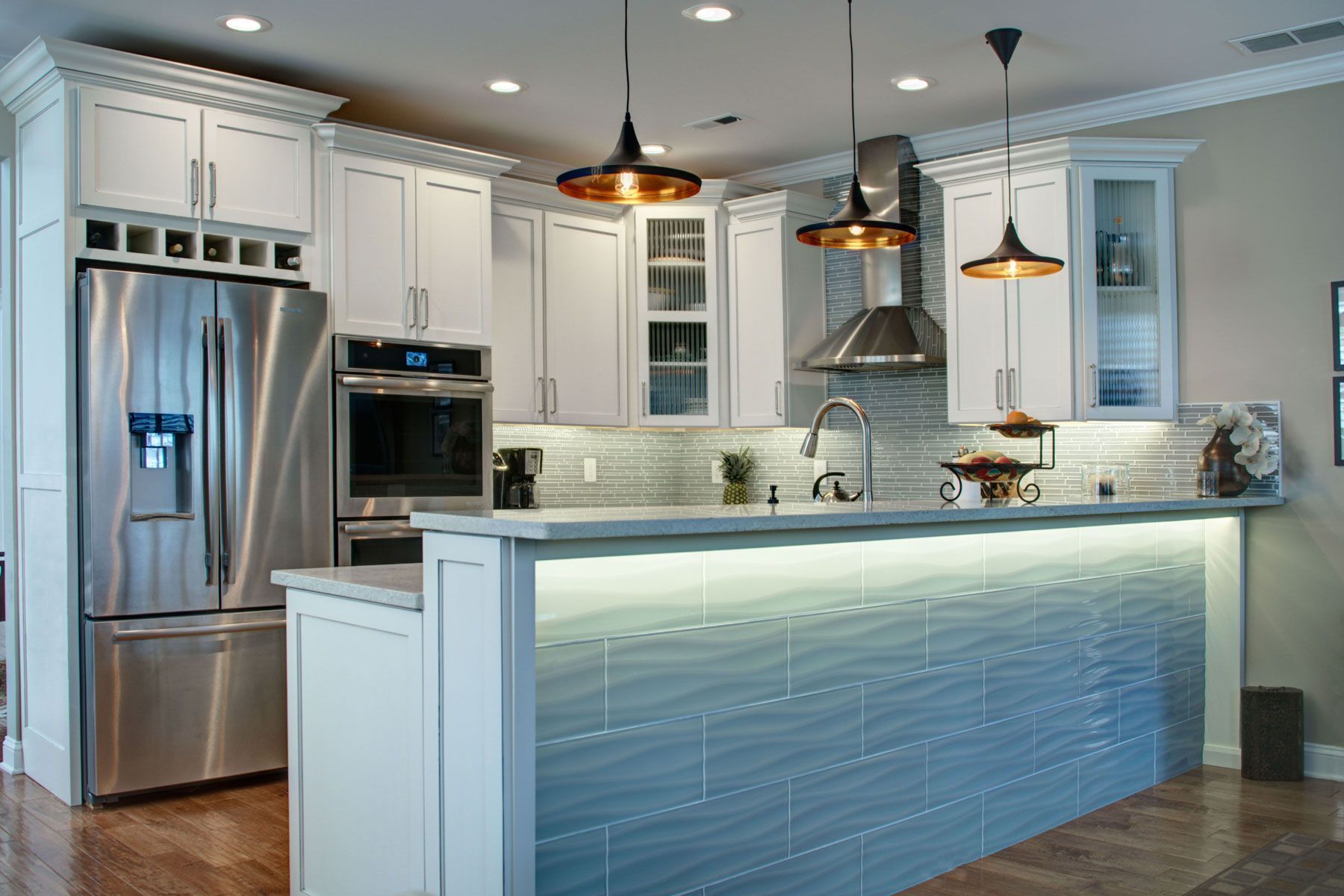 Two-tone kitchen with light blue island cabinets by Diamond Kitchen and Bath