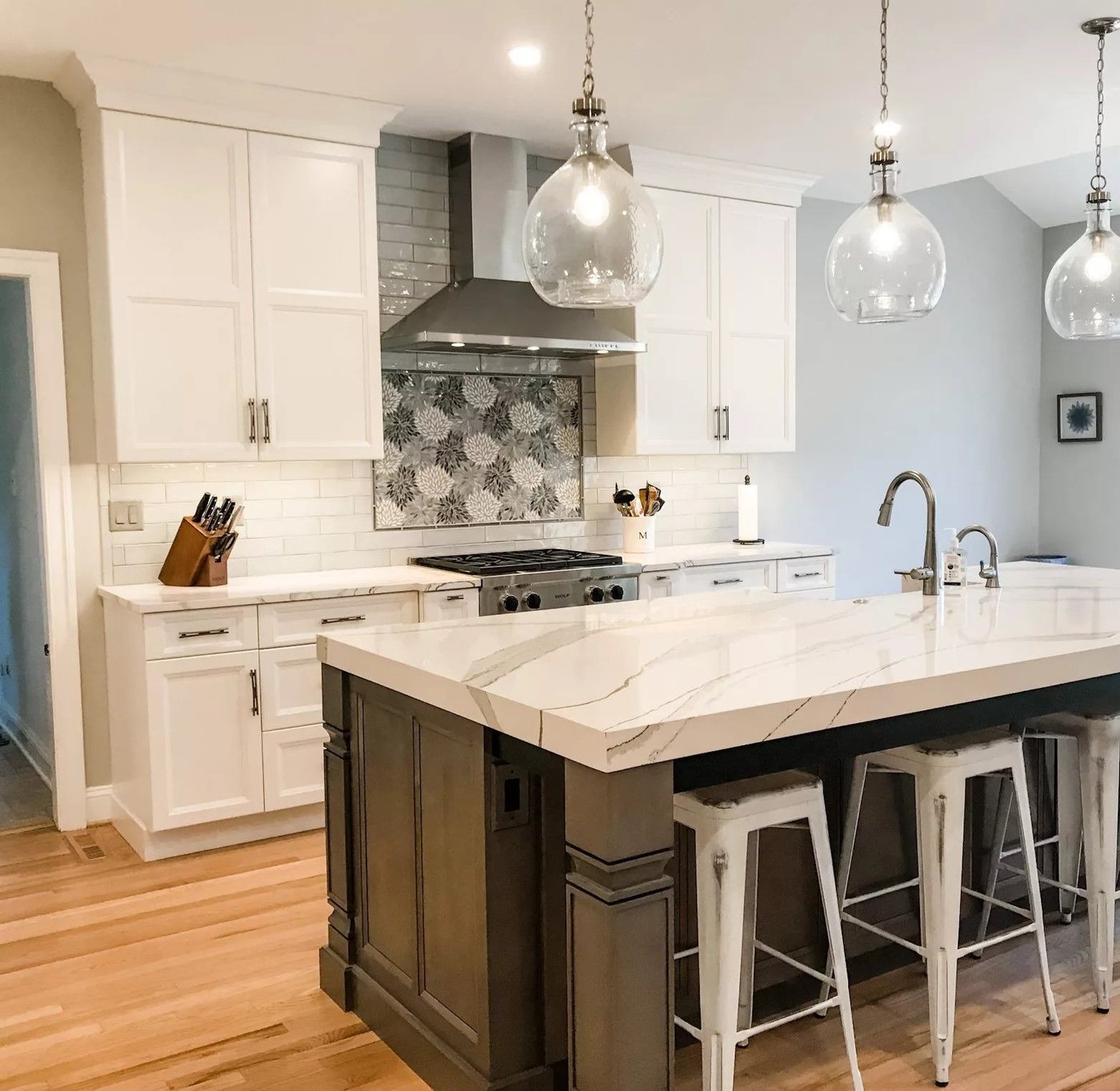 Kitchen with glass pendants and dark island
