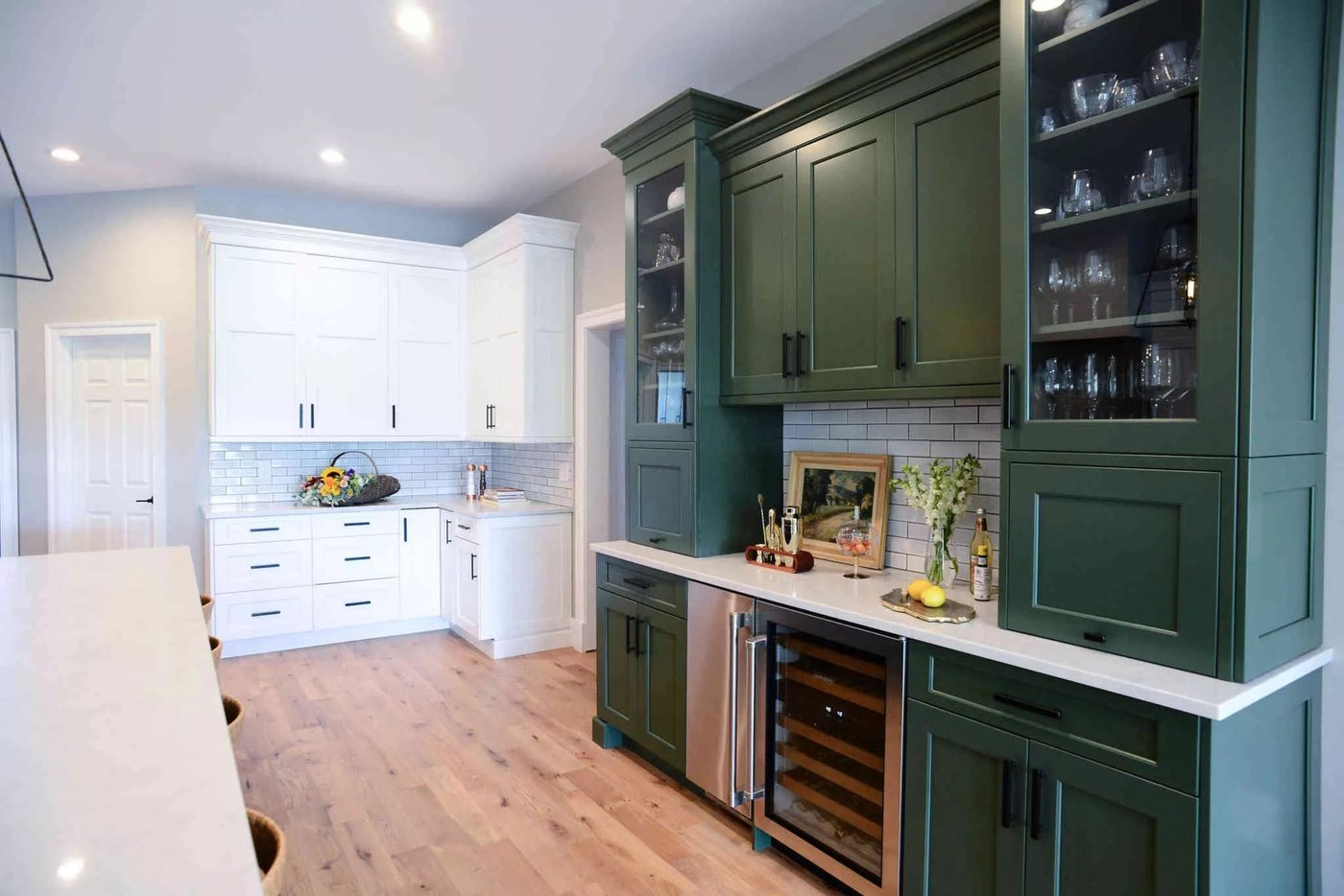 Green cabinetry with bar and wine fridge