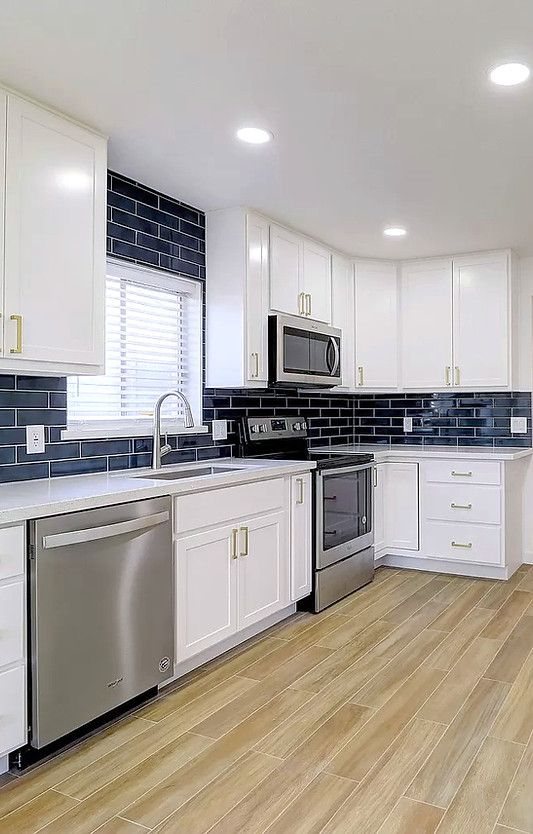 White kitchen with navy subway tile backsplash