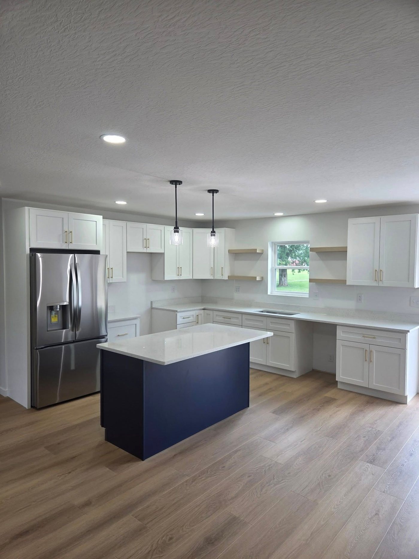 White kitchen with navy center island